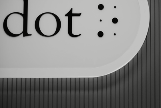 The logo of Dot Inc. displayed in their office.