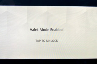 Land Rover Defender’s AVN UI with a phrase 'Valet Mode Enabled' and 'TAP TO UNLOCK' on it