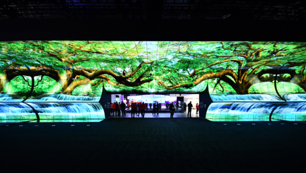 The front view of LG OLED Horizon installed at CES 2023 displaying tress and water falls