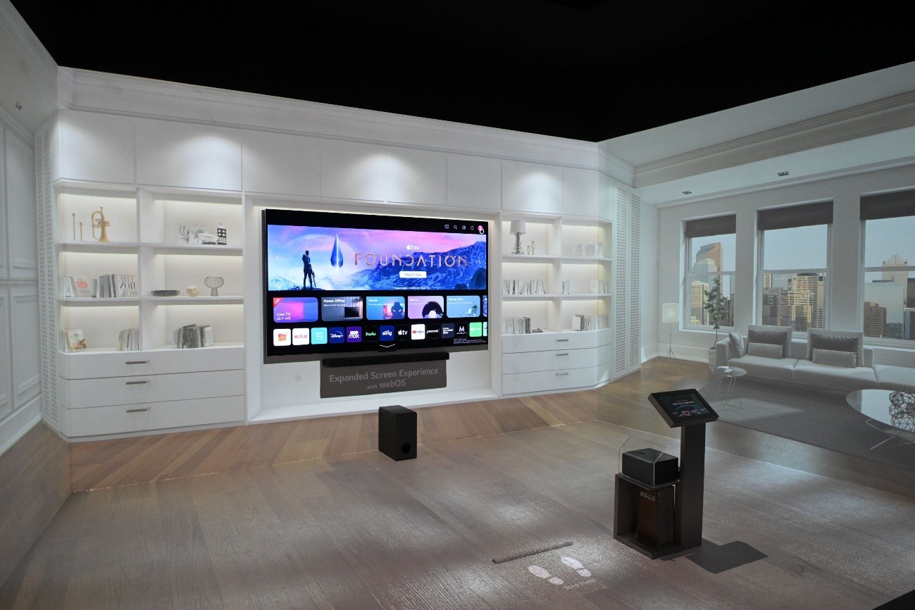 LG OLED TV mounted on the wall of a display room while screening the newly updated webOS UI at CES 2023 to showcase the expanded screen experience with webOS