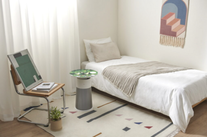 LG PuriCare Aero Furniture in Crème Grey with a special-edition camouflage table-top in a bedroom.