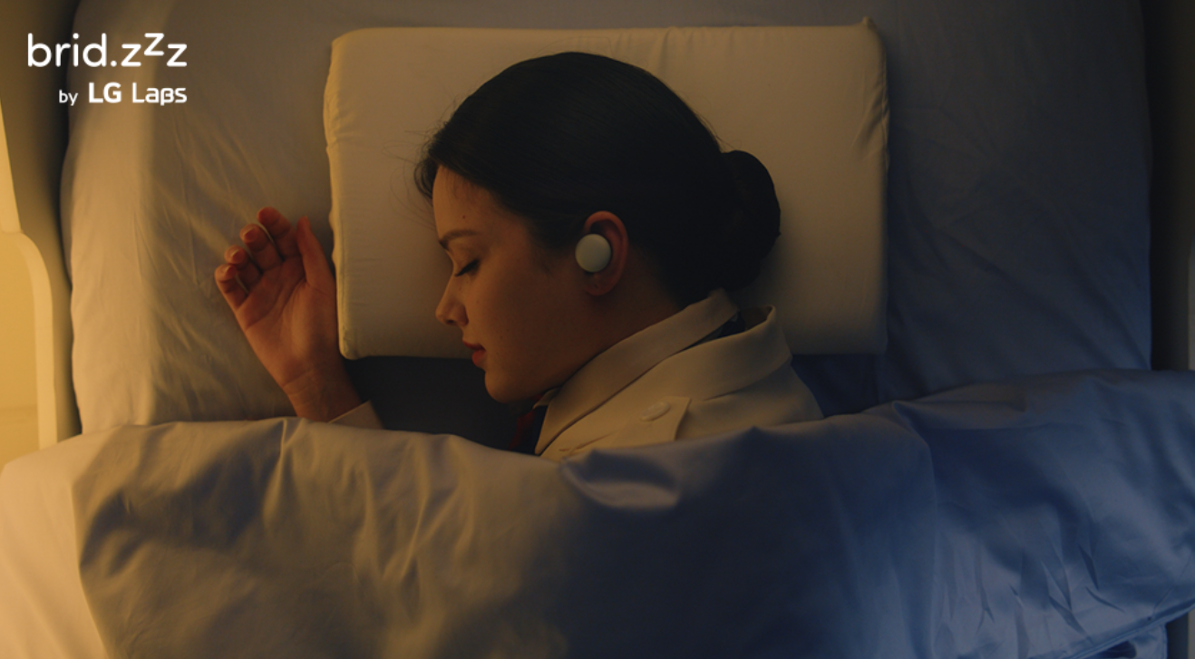 A photo of a woman using the brid.zzz wireless earbuds during her sleep
