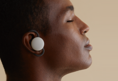 An image of a man using the brid.zzz wireless earbuds with his eyes closed