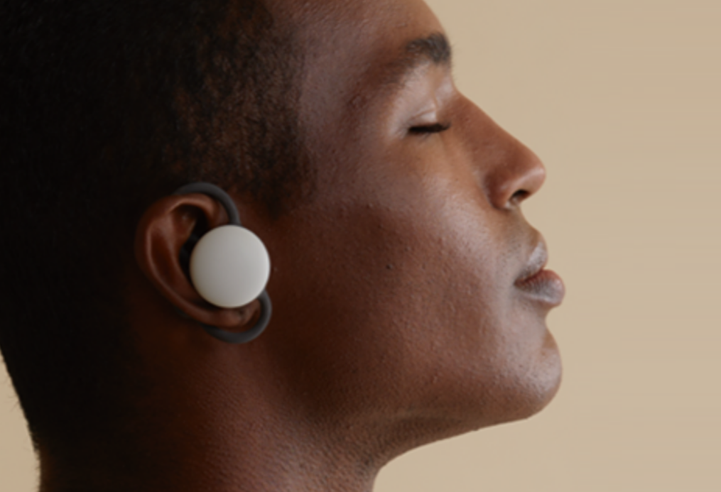 An image of a man using the brid.zzz wireless earbuds with his eyes closed
