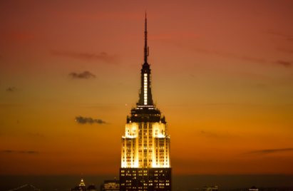 The photo of the top of Empire State Building at sunset