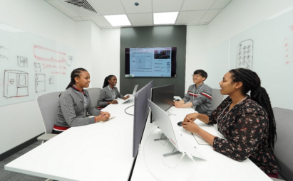 Four people of LG Electronics Middle East having a meeting in a room