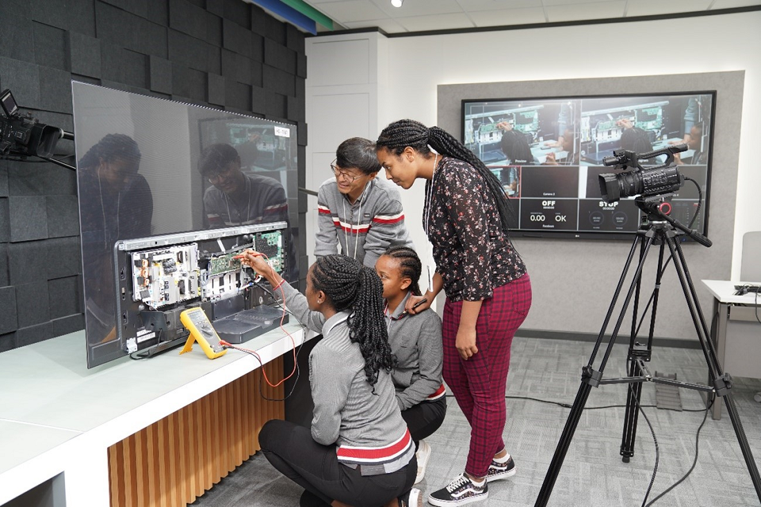 Four people of LG Electronics Middle East inspecting LG TV