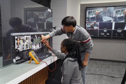 Libanos Tadiyos working with the director to inspect LG TV