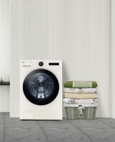 LG Washer with a basket of laundry next to it