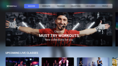 The Xponential+ home screen showing a video of an exercise class with a trainer welcoming exercisers with open arms