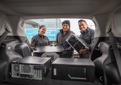 Three staff smiling while participating LG’s E-Waste Drive