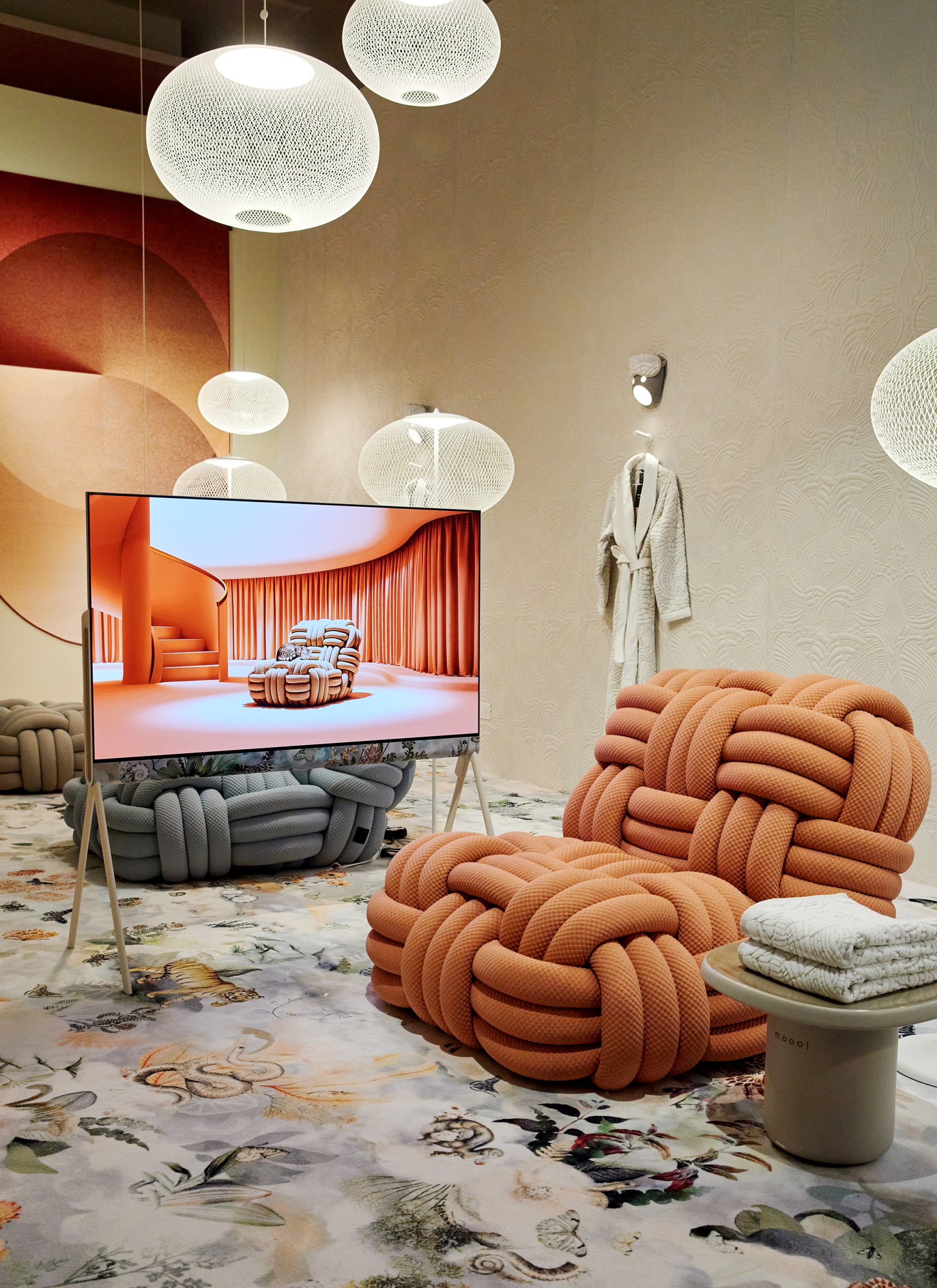 LG OLED Objet Collection Posé next to a stylish orange sofa in a space designed by Dutch brand Moooi