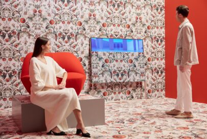 A man and women enjoying the artistic white and red Moooi space designed to display LG OLED Objet Collection Posé and LG PuriCare AeroFurniture in unique patterns and colors