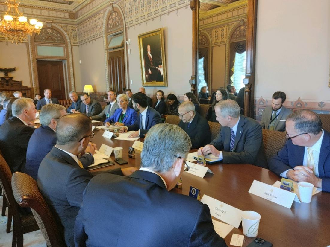 People discussing the agenda for White House Roundtable