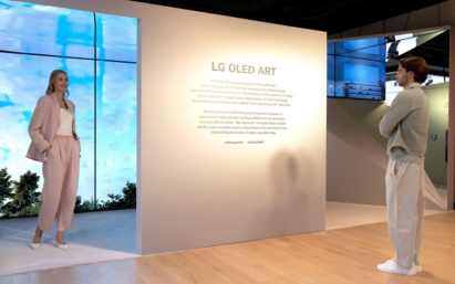 A man and a woman reading a description of the LG OLED Art exhibition on site