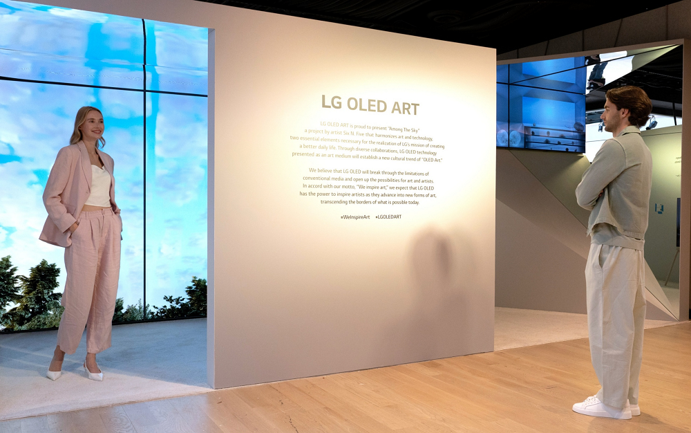 A man and a woman reading a description of the LG OLED Art exhibition on site