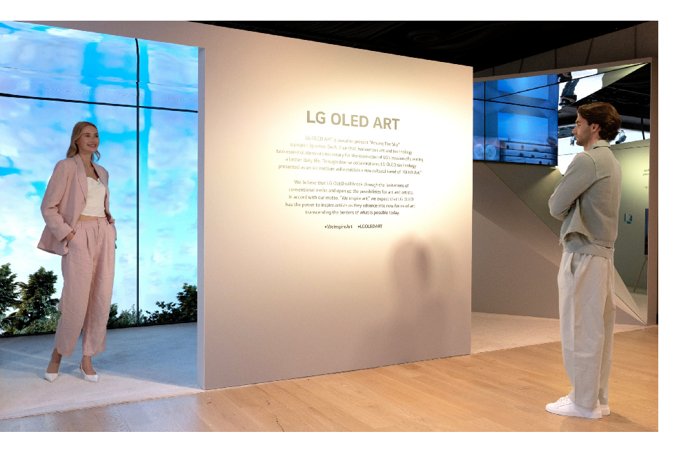 A man and a woman reading a description of the LG OLED Art exhibition on site