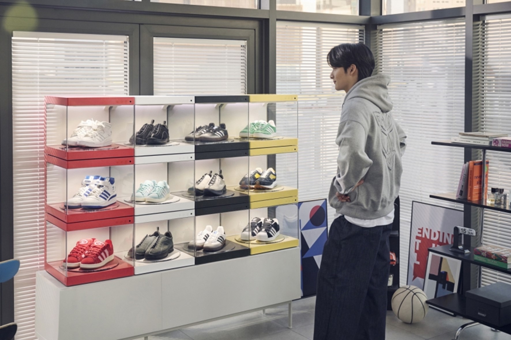 A man looking at a series of shoes neatly organized in LG Styler ShoeCase and ShoeCare