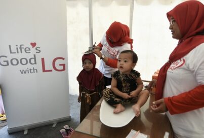 A photo of staff performing a general health checks for children under LG LOVES Indonesia campaign