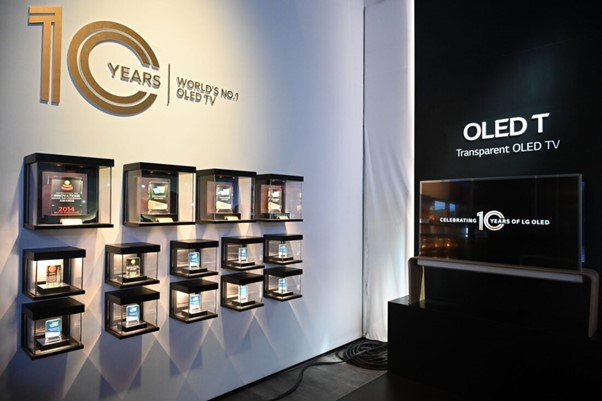 Various awards being displayed next to LG’s Transparent OLED TV at an exhibition hall commemorating LG OLED TV’s 10-year anniversary
