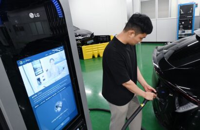 A person using LG EV Charger at a parking lot