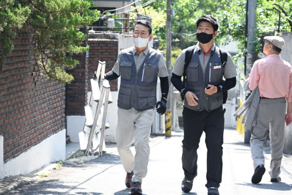 LG CEO walking around districts in Hongdae, Korea, with a ladder in his hand