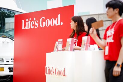 Staff standing behind the desk prepared for the Life's Good event