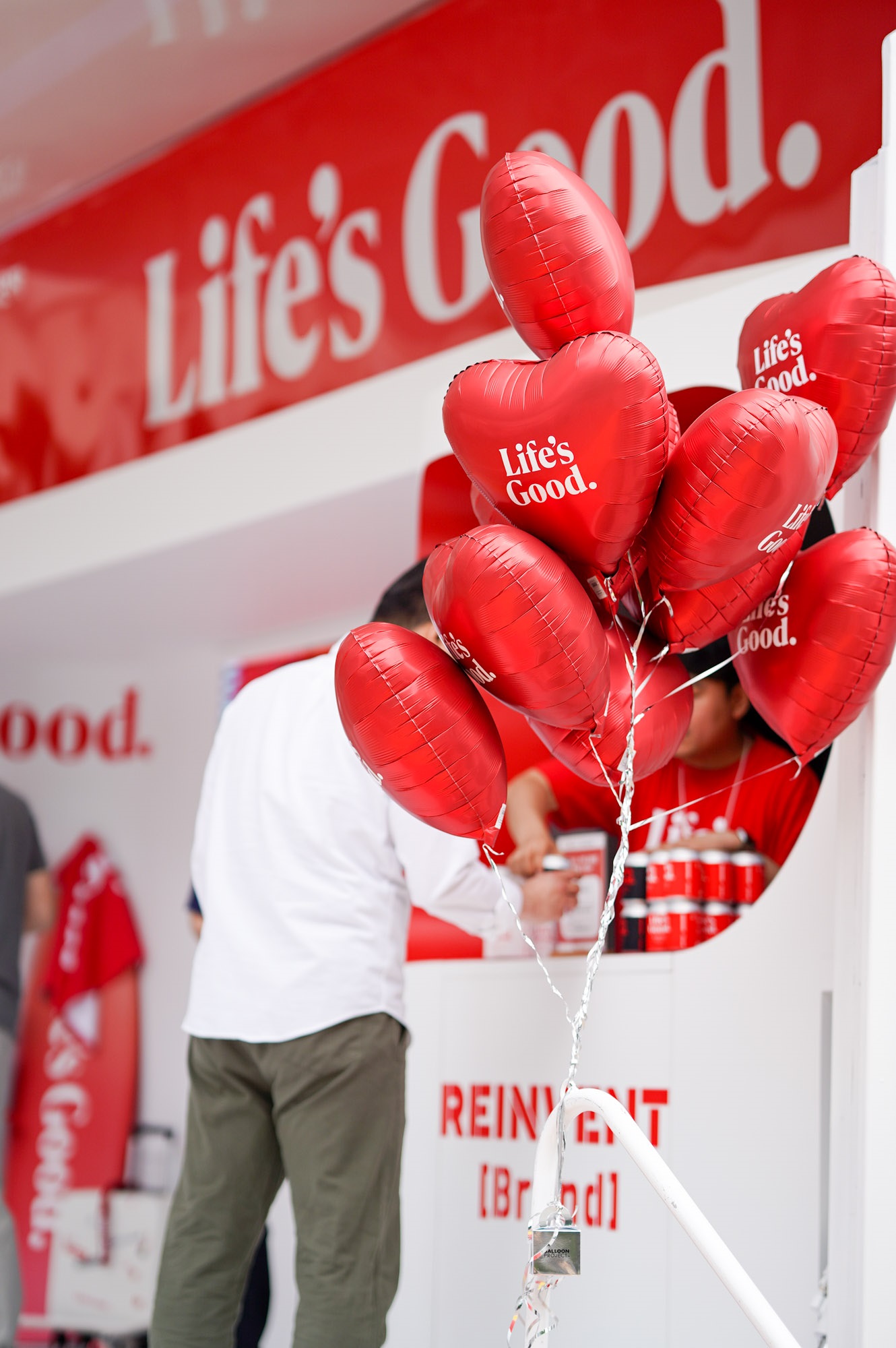 A close-up photo of a bunch of red balloons with the phrase "Life's Good"