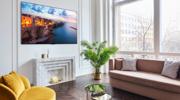 A 2023 LG OLED TV mounted on the wall of a bright, modern living room