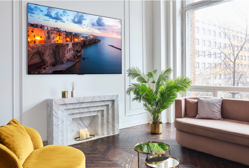 A 2023 LG OLED TV mounted on the wall of a bright, modern living room