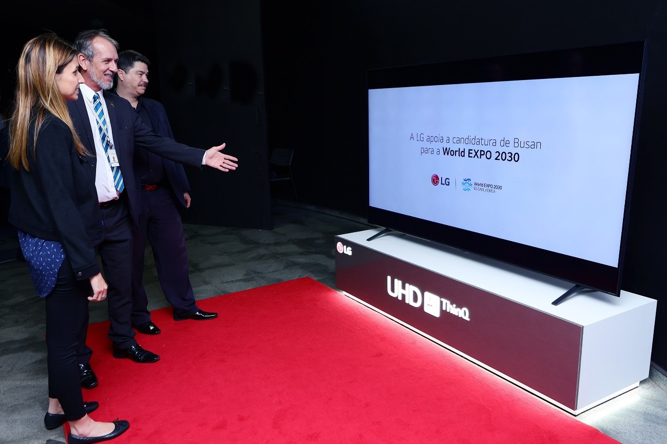 A photo people watching a promotional video for the 2030 Busan World Expo played on LG LED TV