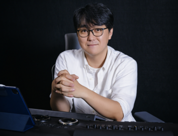 Colorist Park Jin-ho sitting at his work desk which boasts various high-tech electronic equipment