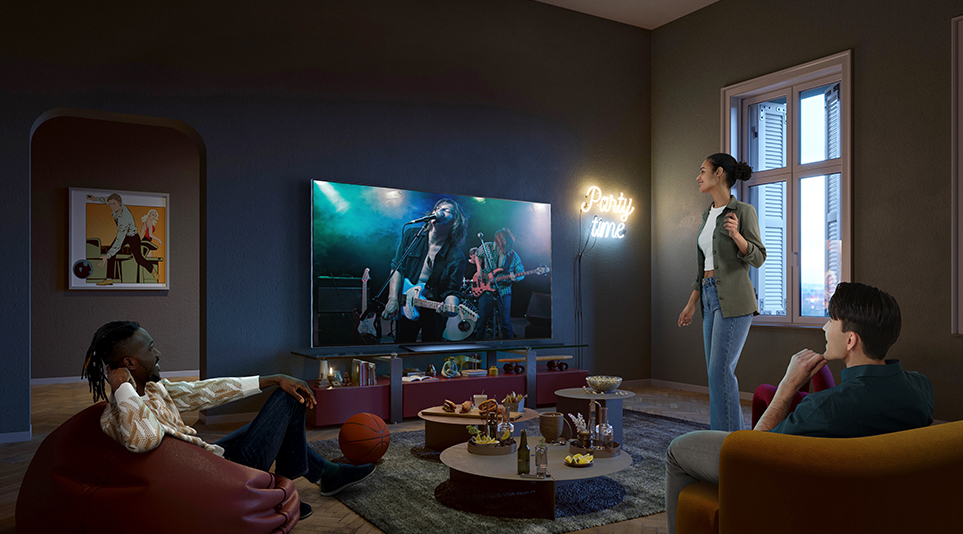 Three friends enjoying a music concert on an LG OLED TV with drinks in a moderately bright living room