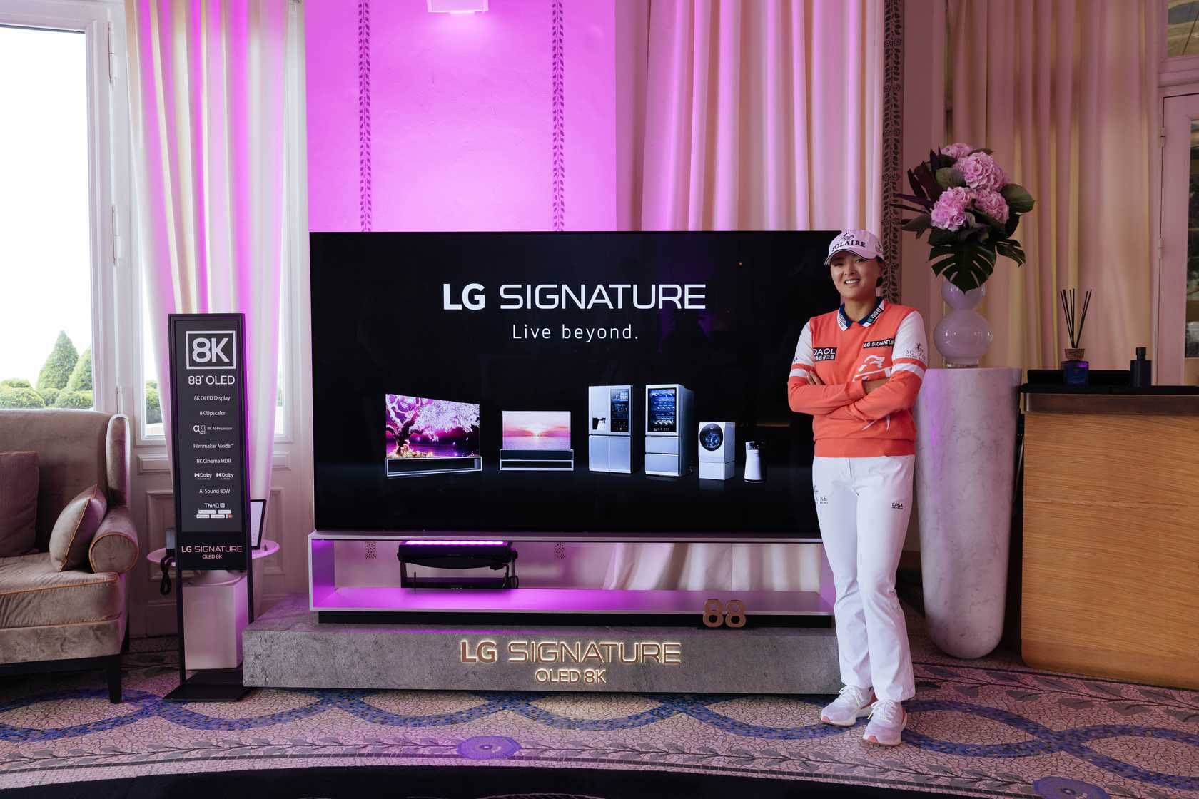 Golfer Ko Jin-young posing in front of LG SIGNATURE OLED TV