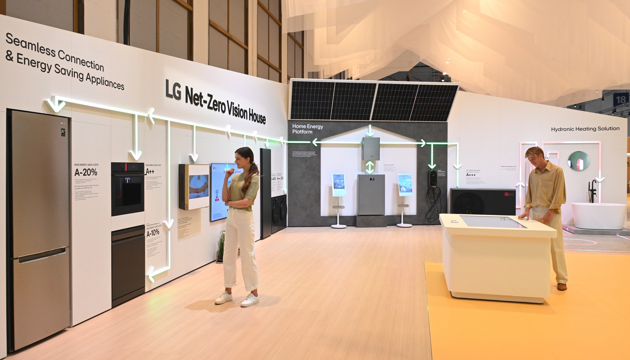 Two people at LG booth prepared for IFA 2023