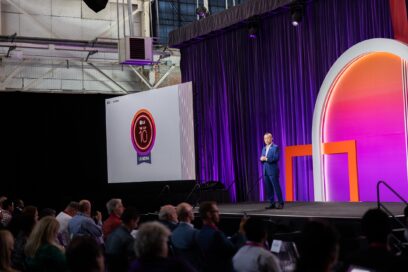 A photo of a LG NOVA event where Sokwoo Rhee is giving a speech