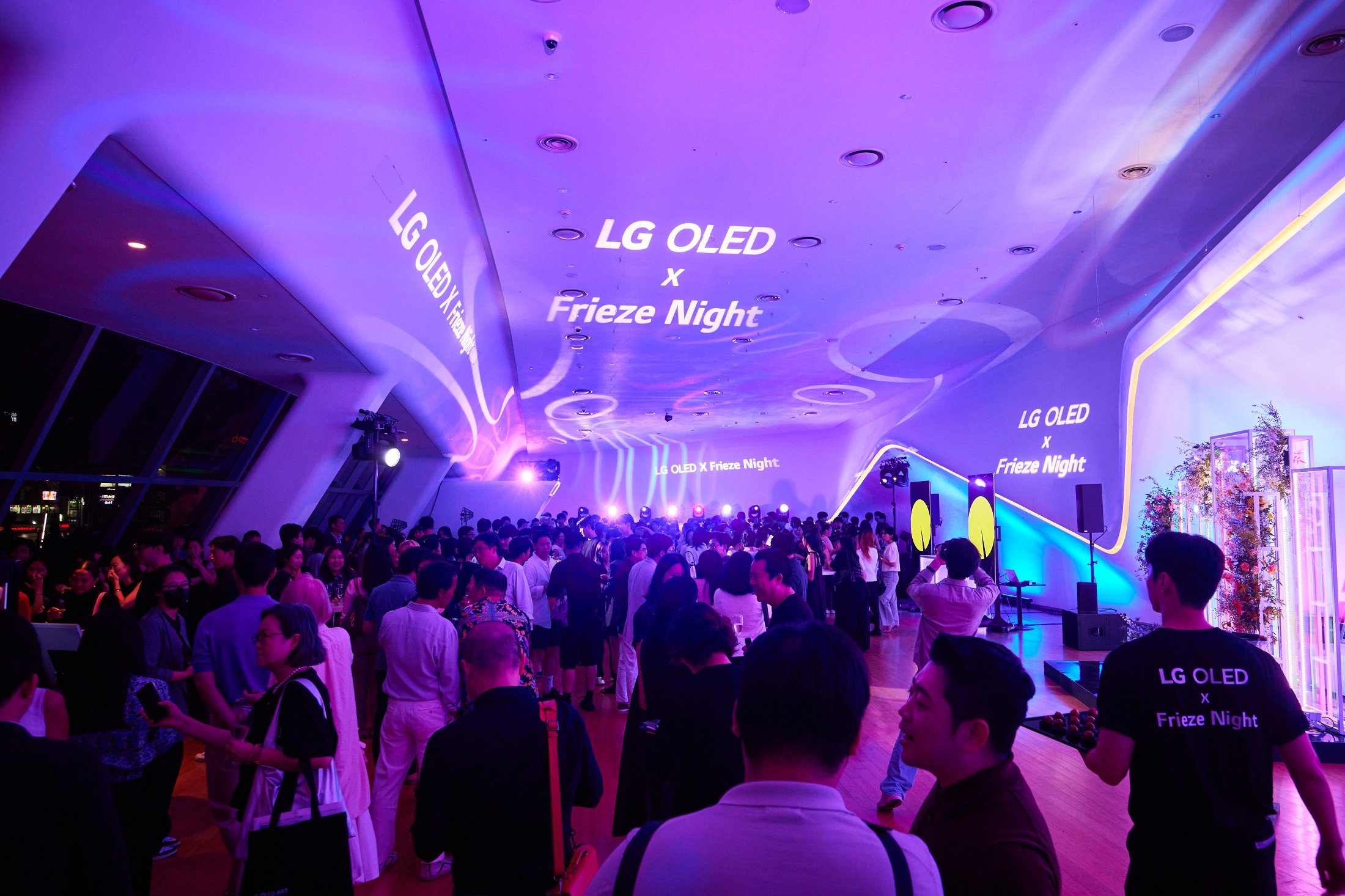 A large crowd socializing at Dongdaemun Design Plaza during LG OLED X Frieze Night