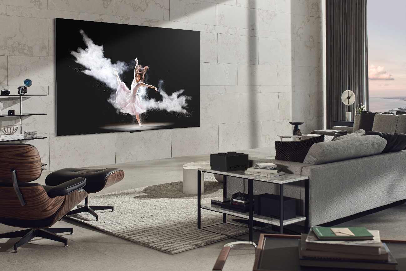 LG SIGNATURE OLED M3 TV mounted on the wall of a gray-themed living room as it displays a ballet performance