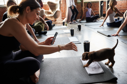 A woman taking a picture of a puupy during the session