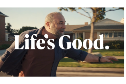 An image of a man riding a longboard with a phrase "Life's Good." overlapping