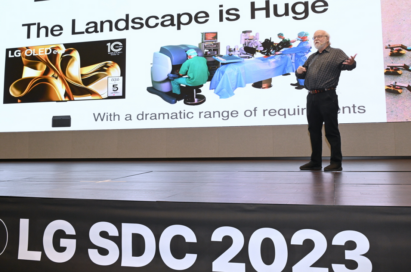 A photo of a man giving a presentation on the podium during Software Developer Conference 2023 with LG TV on screen