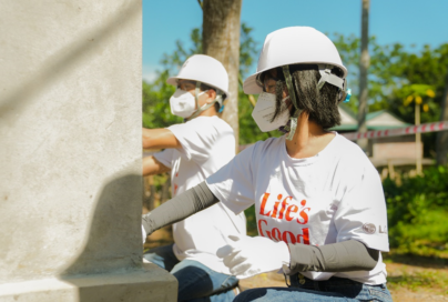 LG Vietnam employees painting a wall to renovate an old house