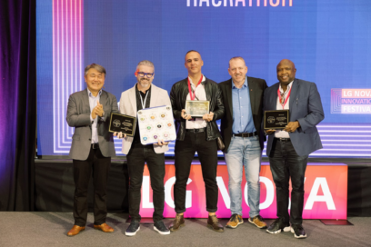 A photo of the winners of the webOS Hackathon standing next to each other posing for the camera with their awards