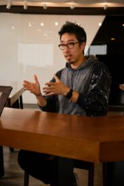 A photo of Choi Joong-ho, professional at LG's Brand Strategy Team, sitting down on a table explaining something while using hand motions