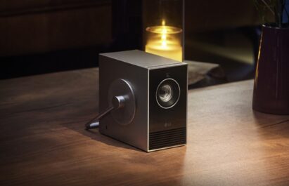 LG CineBeam Qube placed next to a candle