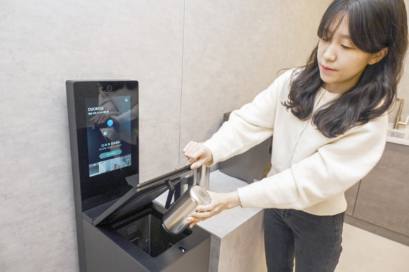 A photo of a woman cleaning a tumbler with LG mycup tumbler washer