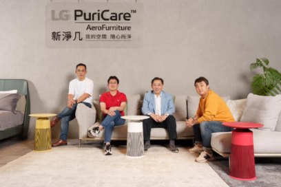 A photo of four men posing for the camera with LG PuriCare AeroFurnitures placed between them