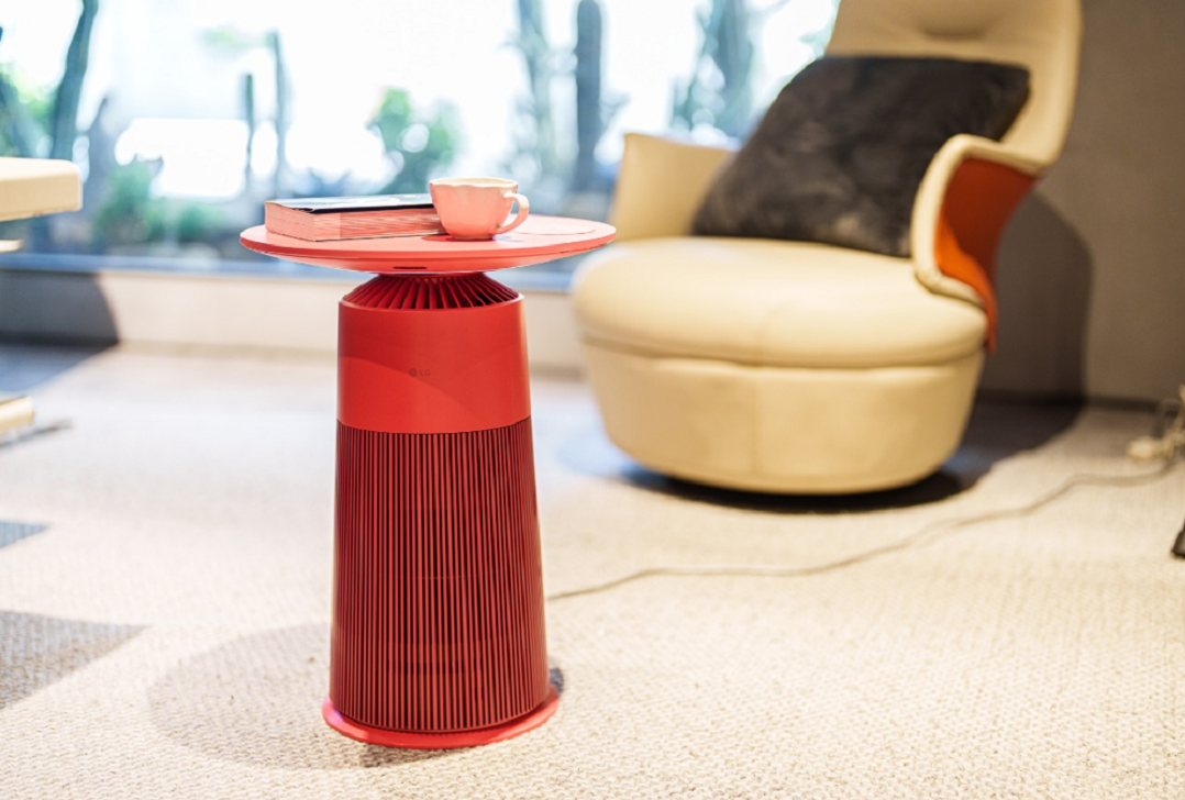 An image of a red LG PuriCare AeroFurniture placed in a living room setting