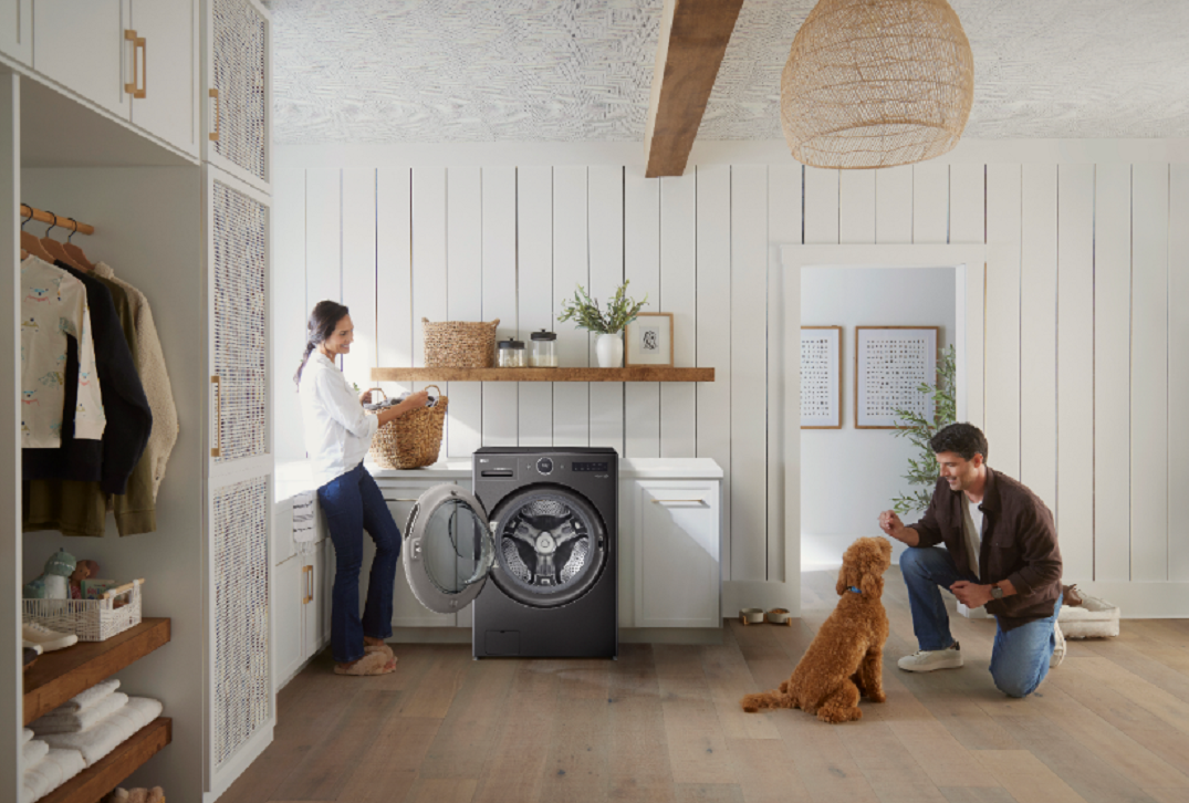 Image of a woman using the LG WashCombo and a man with a dog next to her