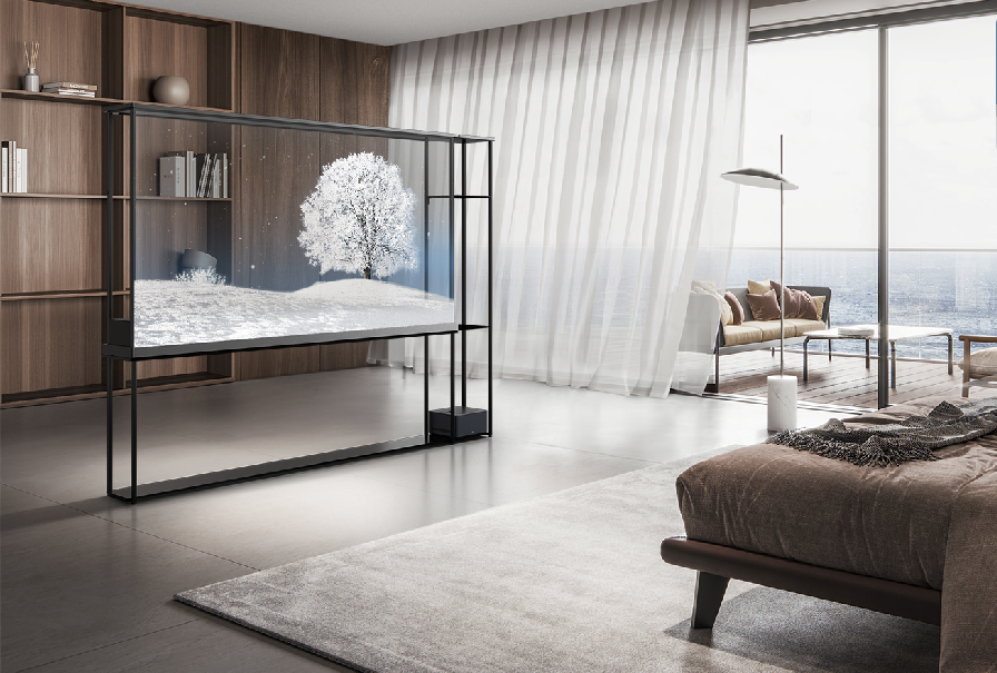 LG OLED T displays a snowy scene in a bedroom with a bookshelf visible behind the transparent screen